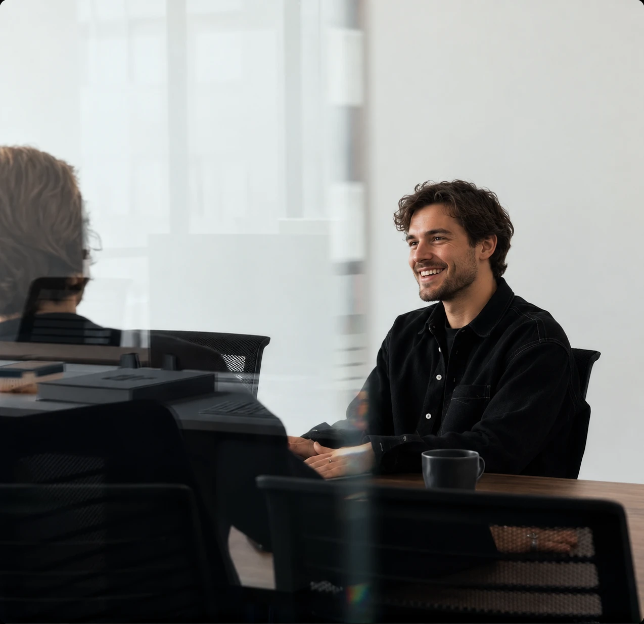 AGS team member meeting with a client in a bright conference room